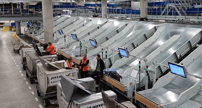 Staff near an cross belt sorter integration system