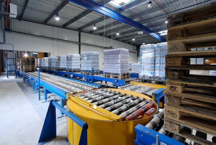 Stacked pallets with shipping conveyor