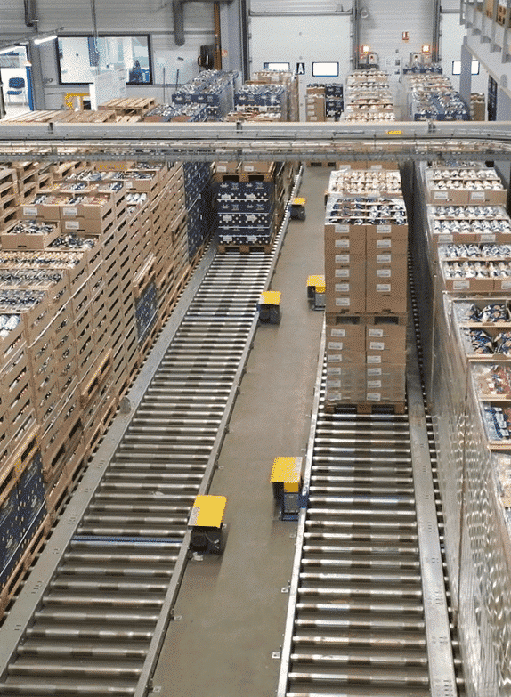 Warehouse full of pallets on conveyors